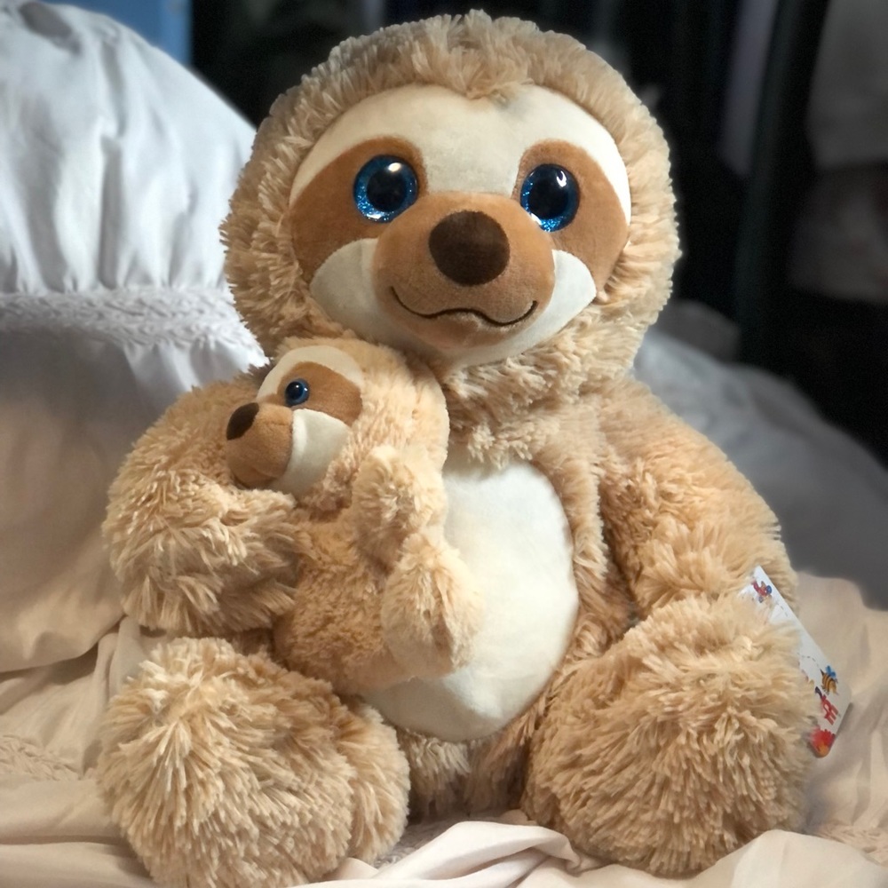 Plushy sloth and baby. Brand new with tag. 18 in. Tall. Very soft and cute.